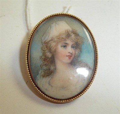 Lot 295 - A brooch with a painted miniature of a young lady in a beaded oval frame