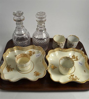 Lot 332 - Two cut glass decanters, four gilt cups and two shaped porcelain dishes