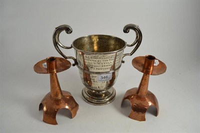 Lot 346 - A silver twin handled trophy cup and a pair of copper candlesticks (3)