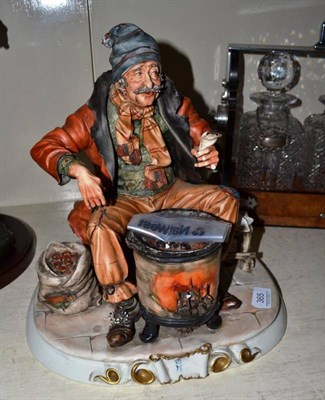 Lot 365 - A large Capodimonte figure of a man roasting his chestnuts