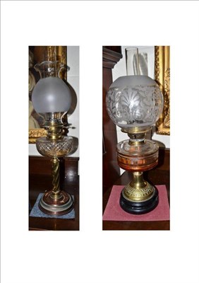 Lot 375 - Two Victorian brass oil lamps with chimneys and shades