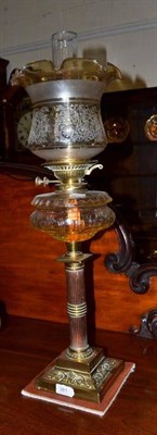 Lot 381 - A Victorian brass and copper reeded column oil lamp with chimney and shade