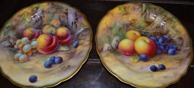 Lot 386 - A pair of Royal Worcester fruit painted porcelain plates with gilt gadroon boarder, with fruit on a