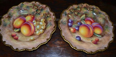 Lot 387 - A pair of Royal Worcester fruit painted porcelain plates, with gilt gadroon boarder, with fruit...