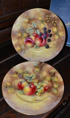 Lot 388 - A pair of Royal Worcester fruit painted porcelain plates, J Smith, with fruit on a mossy bank,...