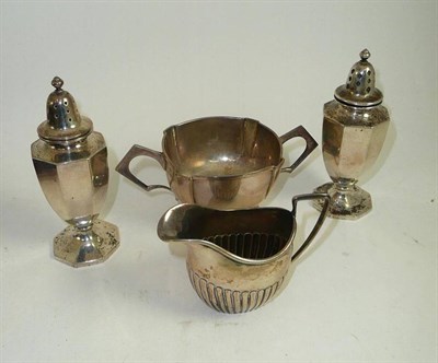 Lot 402 - Pair of silver pepperettes, silver twin-handled sugar and a cream jug (4)