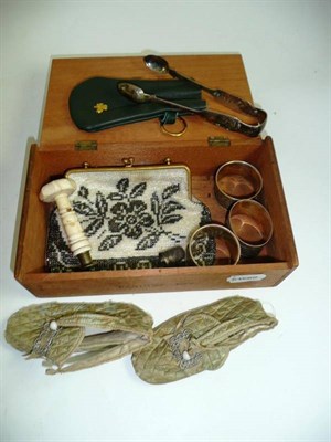 Lot 407 - Box of sundry including beaded bag, silver serviette rings, a pair of Newcastle silver sugar...