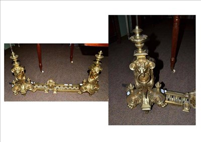 Lot 526 - A brass chenet with lion head terminals and paw feet