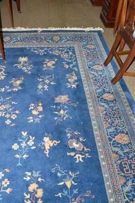 Lot 531 - Machine made carpet of Chinese design Europe,  The mid indigo field with columns of floral...