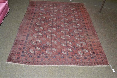 Lot 532 - An Afghan 'Tekke' rug, North west Afghanistan, the madder field of quartered guls enclosed by...