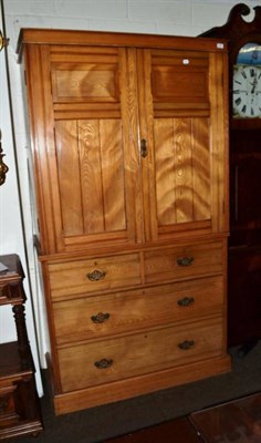 Lot 539 - A late Victorian ash linen press fitted cupboard doors enclosing four sliding trays above two short