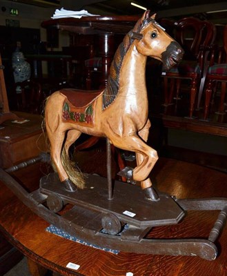 Lot 554 - A reproduction rocking horse