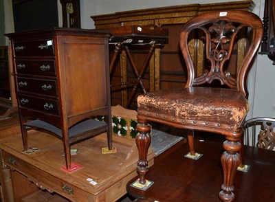 Lot 559 - A Victorian balloon back chair and a music cabinet