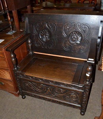 Lot 577 - A carved oak monk's bench