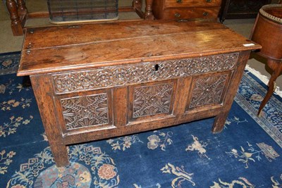 Lot 582 - A 17th century joined oak chest boarded lid above with later carved frieze and three fielded panels