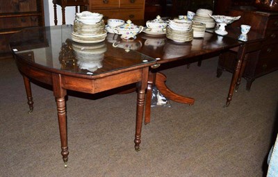 Lot 585 - George III mahogany dining table