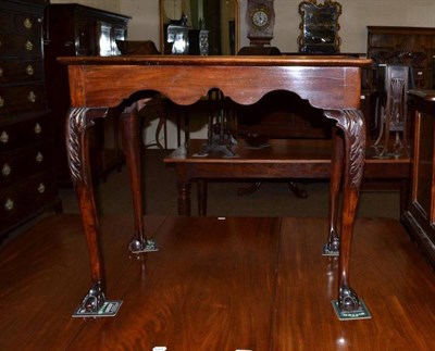 Lot 588 - A George II style mahogany silver table of rectangular form raised on acanthus carved cabriole legs