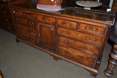 Lot 590 - 18th century oak dresser with an arrangement of five drawers either side a central cupboard...