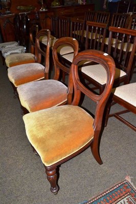 Lot 605 - Four mahogany balloon back dining chairs with overstuffed seats on turned forelegs raised on...