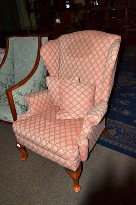 Lot 609 - Wing armchair with cream and red upholstery