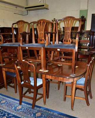 Lot 615 - Georgian mahogany dining table on square tapering legs with brass casters, extra leaf, and  a...