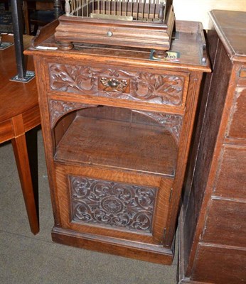 Lot 628 - Oak side cupboard with carved door and drawer