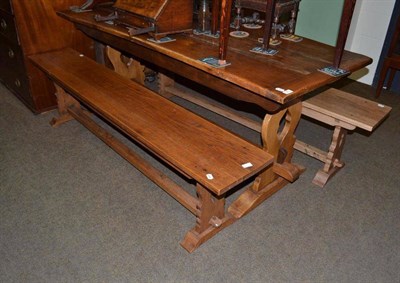 Lot 629 - An oak refectory table of three plank construction with cleated ends, a pair of oak benches on...