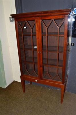 Lot 640 - An Edwardian mahogany glazed china cabinet on raised stand with square tapering legs