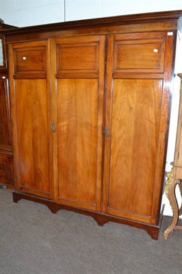 Lot 649 - An early 20th century oak combination triple wardrobe