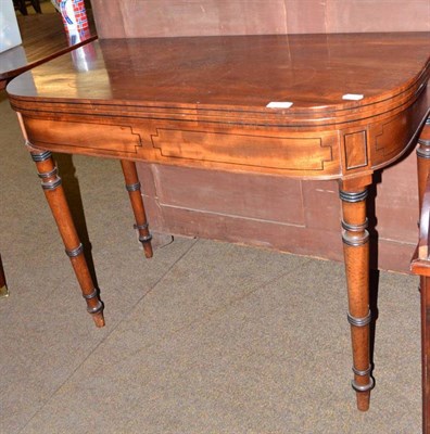 Lot 656 - A Regency mahogany and ebony strung fold over tea table raised on ring turned tapering legs