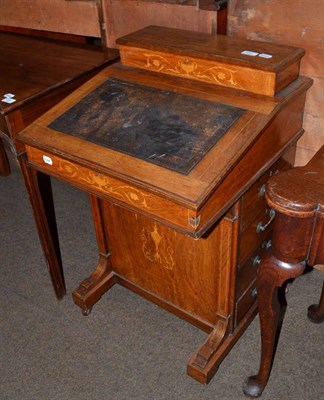 Lot 659 - A late Victorian walnut Davenport with hinged lid and interior veneered in birdseye maple