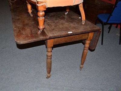 Lot 698 - A 19th century mahogany drop leaf dining table