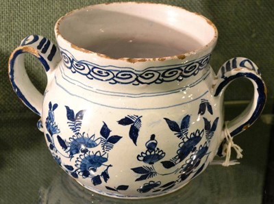 Lot 11 - An English Delft Posset Pot, circa 1720, of baluster form with twin scroll handles, painted in blue