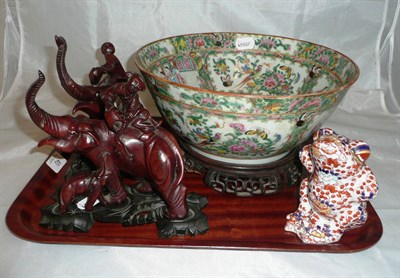 Lot 40 - Cantonese porcelain bowl on hardwood stand, pair of Chinese carved hardwood figures on stands...