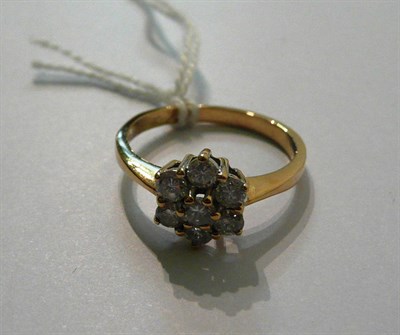 Lot 54 - A diamond cluster ring, seven round brilliant cut diamonds in a yellow claw settings to a...