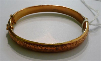 Lot 60 - A 9ct gold hollow stiff hinged bangle, Chester 1918, in original case