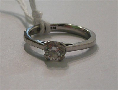 Lot 64 - A platinum diamond solitaire ring, the hexagonal shaped diamond in a four claw setting to a tapered