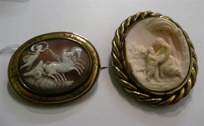 Lot 72 - A pink shell cameo brooch depicting a classical scene, and a cameo brooch depicting a chariot, in a