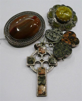 Lot 186 - A large oval agate brooch within a decorative frame, a clover shaped brooch and a Celtic cross,...