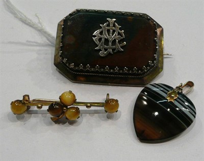 Lot 188 - An agate brooch, with initials CJM overlaid, a heart shaped sardonyx pendant and a tiger's eye...
