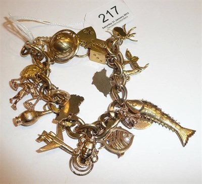 Lot 217 - A gold solid link bracelet hung with approximately 19 charms, cased