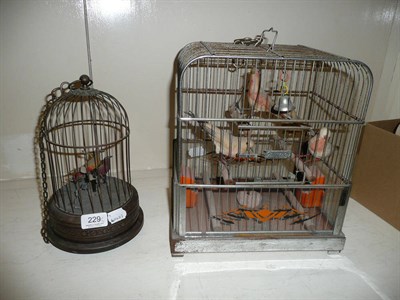 Lot 229 - Brass singing bird cage and another bird cage