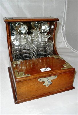 Lot 273 - A tantalus containing two decanters (with original key)