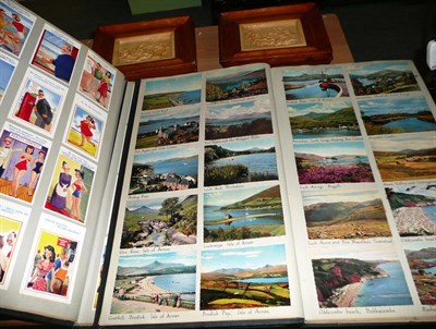 Lot 345 - Four albums of 1960s postcards (approx 1600) and four mahogany frames with cherub relief pictures