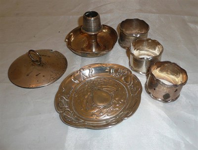 Lot 382 - An Art Nouveau silver dish, three silver napkin rings, a silver match striker/ashtray and a...