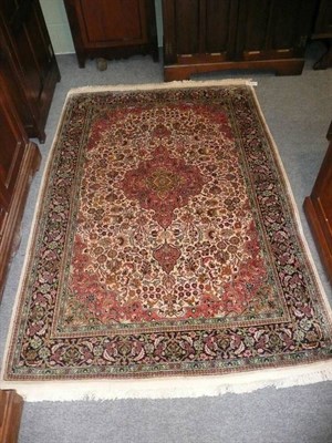 Lot 453 - Kashmir silk Rug North West India The field of scrolling vines around a salmon pink medallion