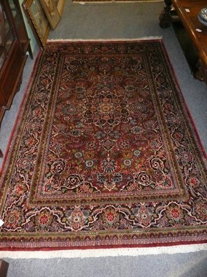 Lot 454 - Kashmir silk rug North West India The strawberry field of flowering plants centred by an indigo...