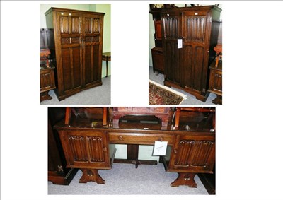 Lot 467 - A linen fold wardrobe, a small wardrobe, a dressing table and bed ends