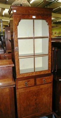 Lot 482 - A reproduction walnut bookcase on cabinet