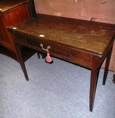 Lot 512 - A George III oak fold-over tea table